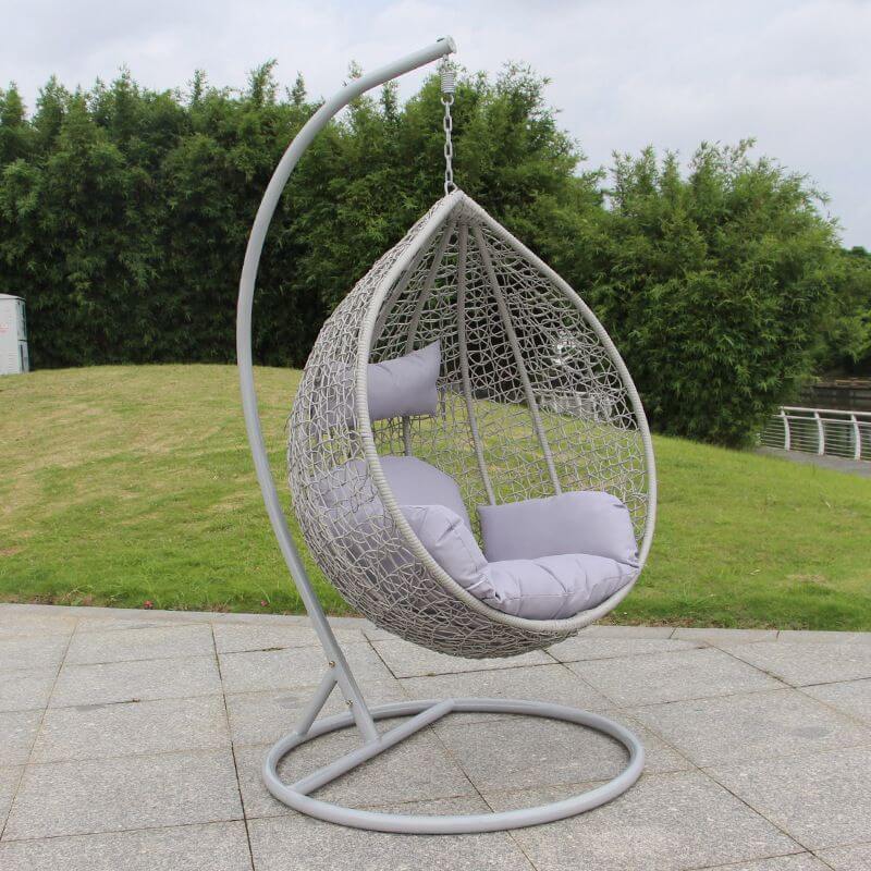 Metal porch swing with stand, cushions, and chain for comfortable outdoor seating