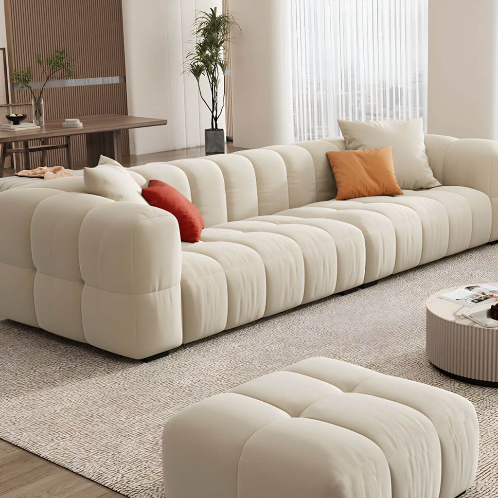 Beige upholstered wood sofa with square arms and sewn pillow back for modern living rooms