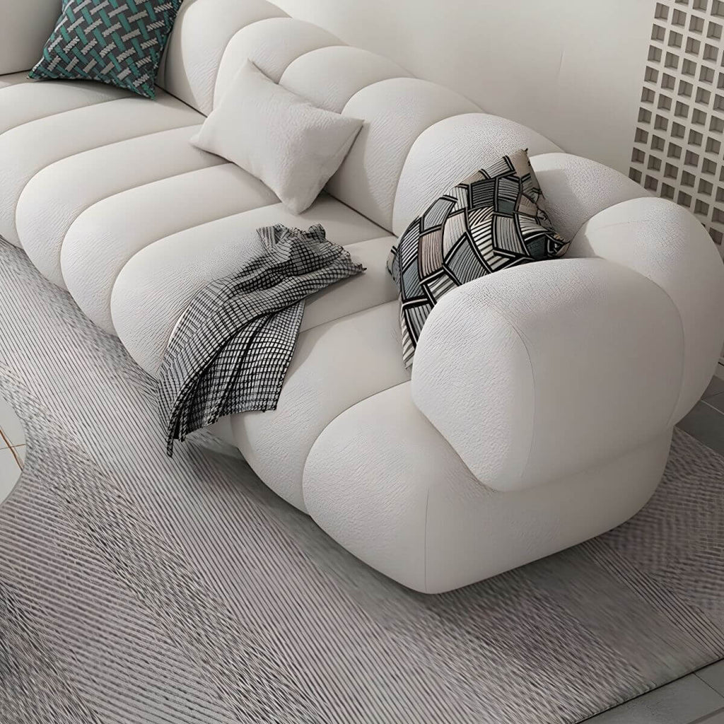 White Scandinavian fabric sofa with biscuit back and tuxedo arms