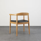 Set of four modern curved back dining chairs with walnut wooden frame and upholstered leather seats