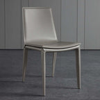 Single dining chair with gray saddle leather seat and carbon steel frame, minimalist luxury design