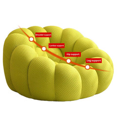 Green football-shaped lazy sofa single chair with 3D knit fabric in a modern living room setting