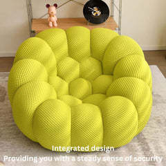 Green football-shaped lazy sofa single chair with 3D knit fabric in a modern living room setting