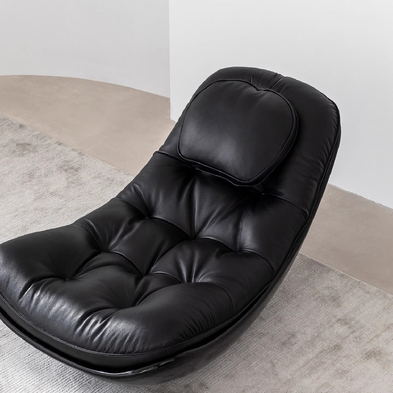 Unique eggshell-shaped recliner in black microfiber