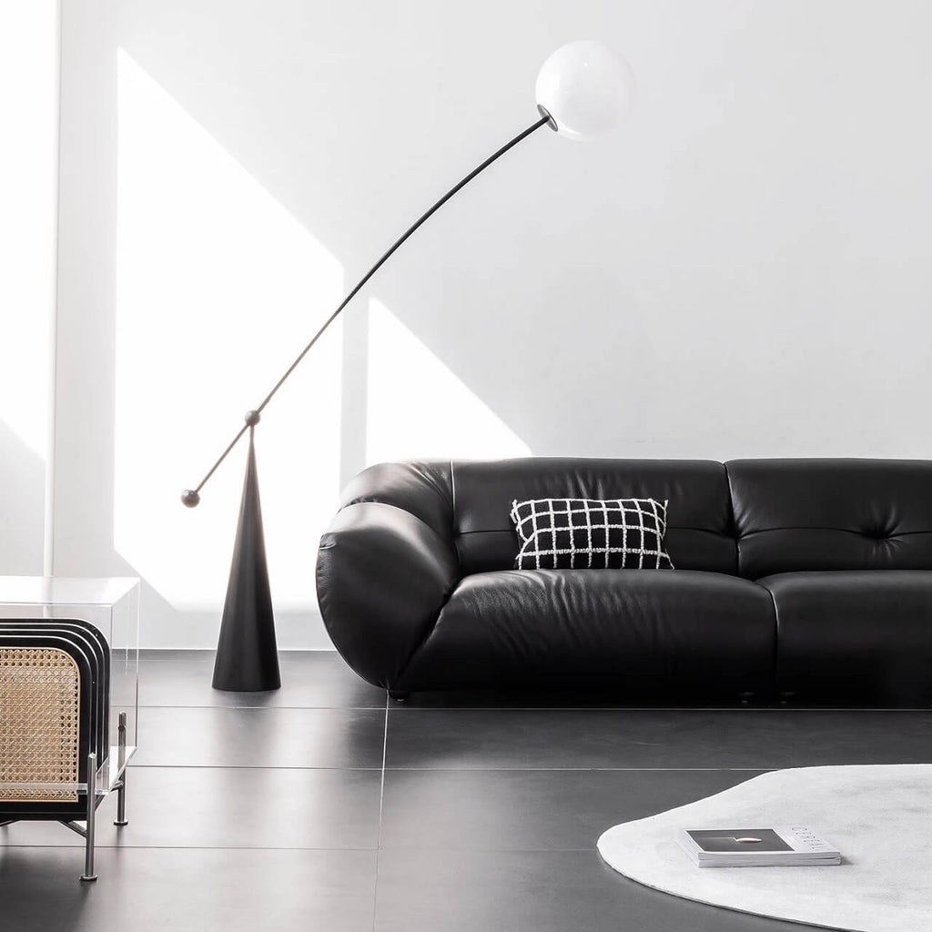 Black microfiber leather sofa with minimalist design, seats three comfortably