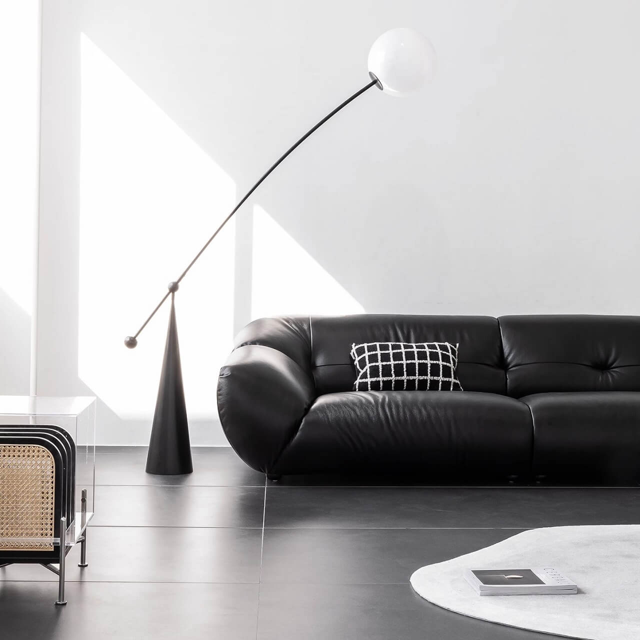 Black microfiber leather sofa with minimalist design, seats three comfortably