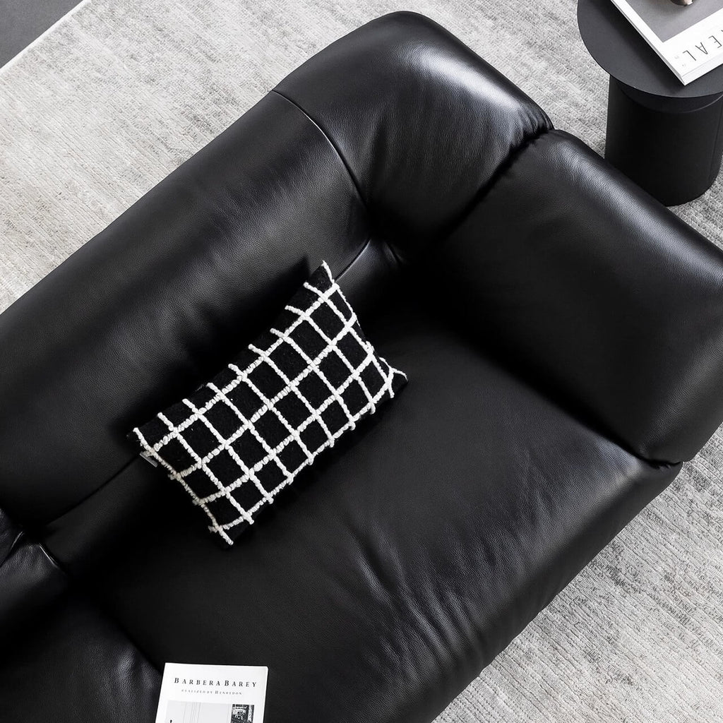 Black microfiber leather sofa with minimalist design, seats three comfortably