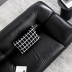 Black microfiber leather sofa with minimalist design, seats three comfortably