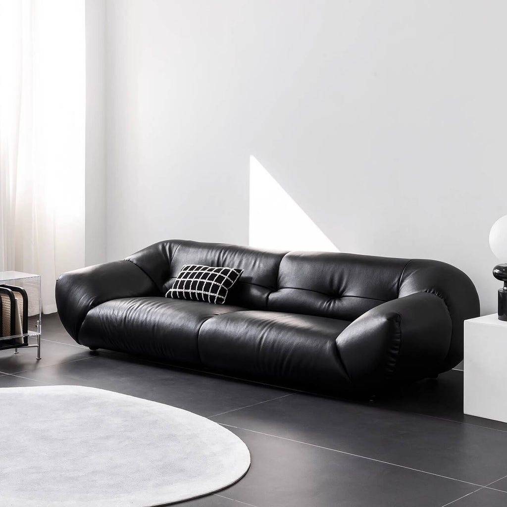 Black microfiber leather sofa with minimalist design, seats three comfortably