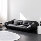 Black microfiber leather sofa with minimalist design, seats three comfortably
