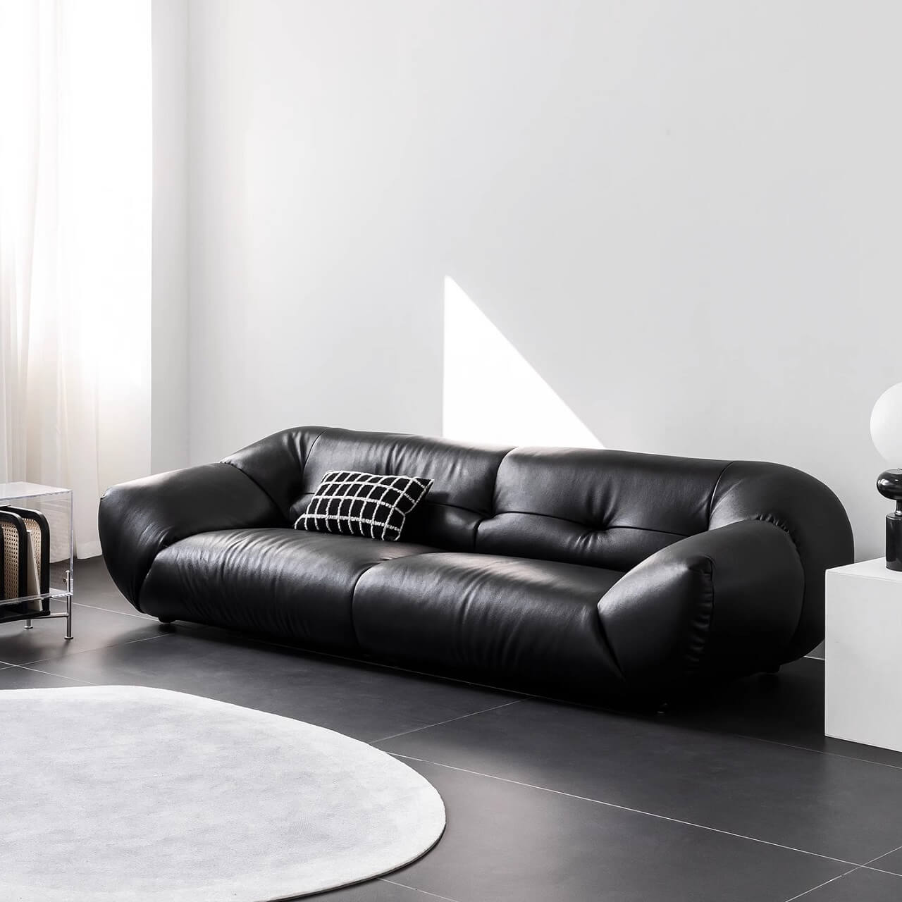 Black microfiber leather sofa with minimalist design, seats three comfortably