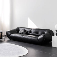 Black leather minimalist sofa seating three comfortably