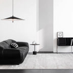 Black microfiber leather sofa with minimalist design, seats three comfortably