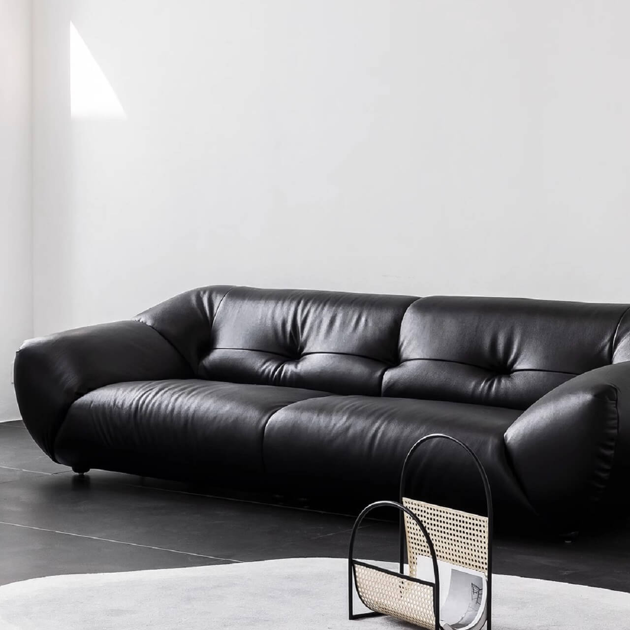 Black microfiber leather sofa with minimalist design, seats three comfortably Main image