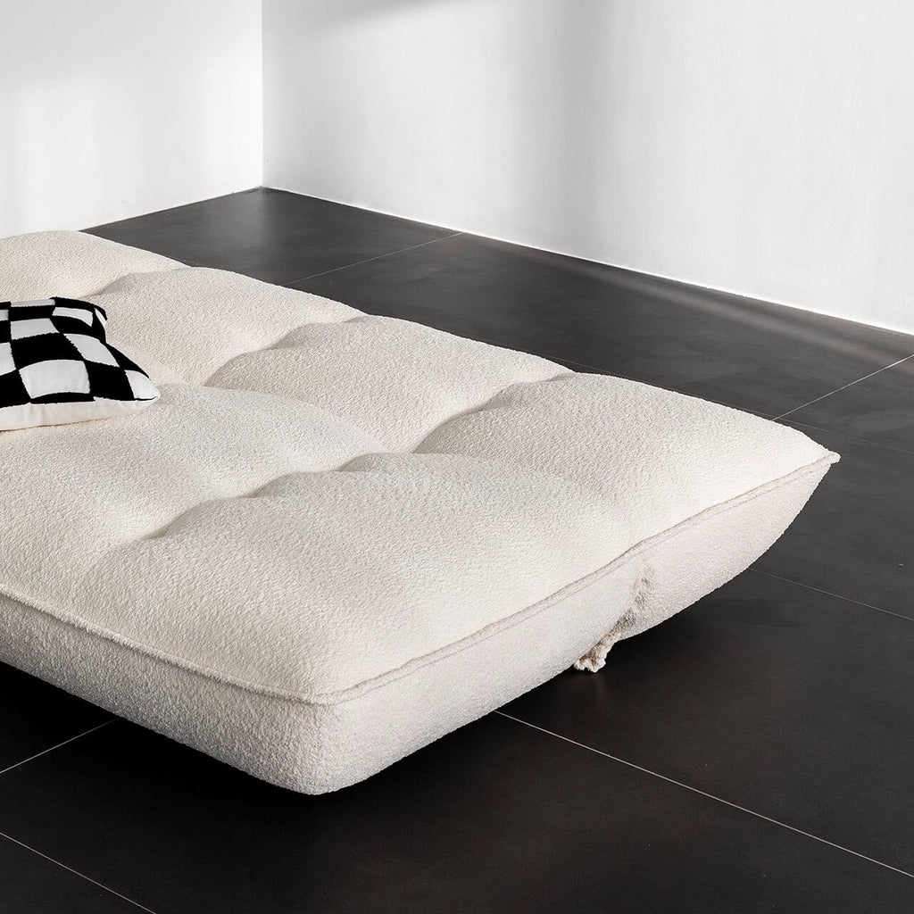 White boucle sofa bed combining comfort, style, and versatility for modern living spaces