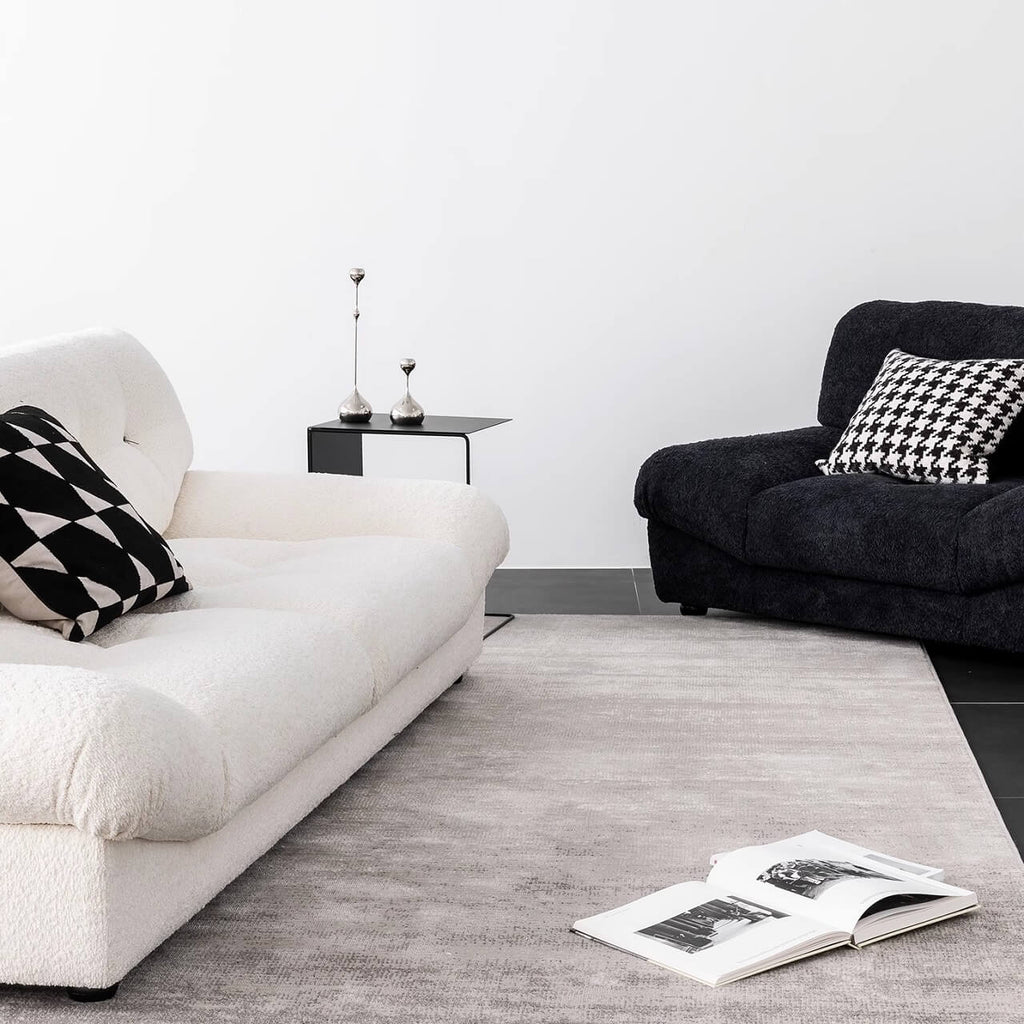 White minimalist boucle sofa with solid wood frame and elegant flared arms