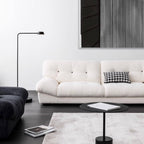 White minimalist boucle sofa with solid wood frame and elegant flared arms