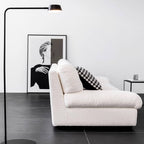 White minimalist boucle sofa with solid wood frame and elegant flared arms