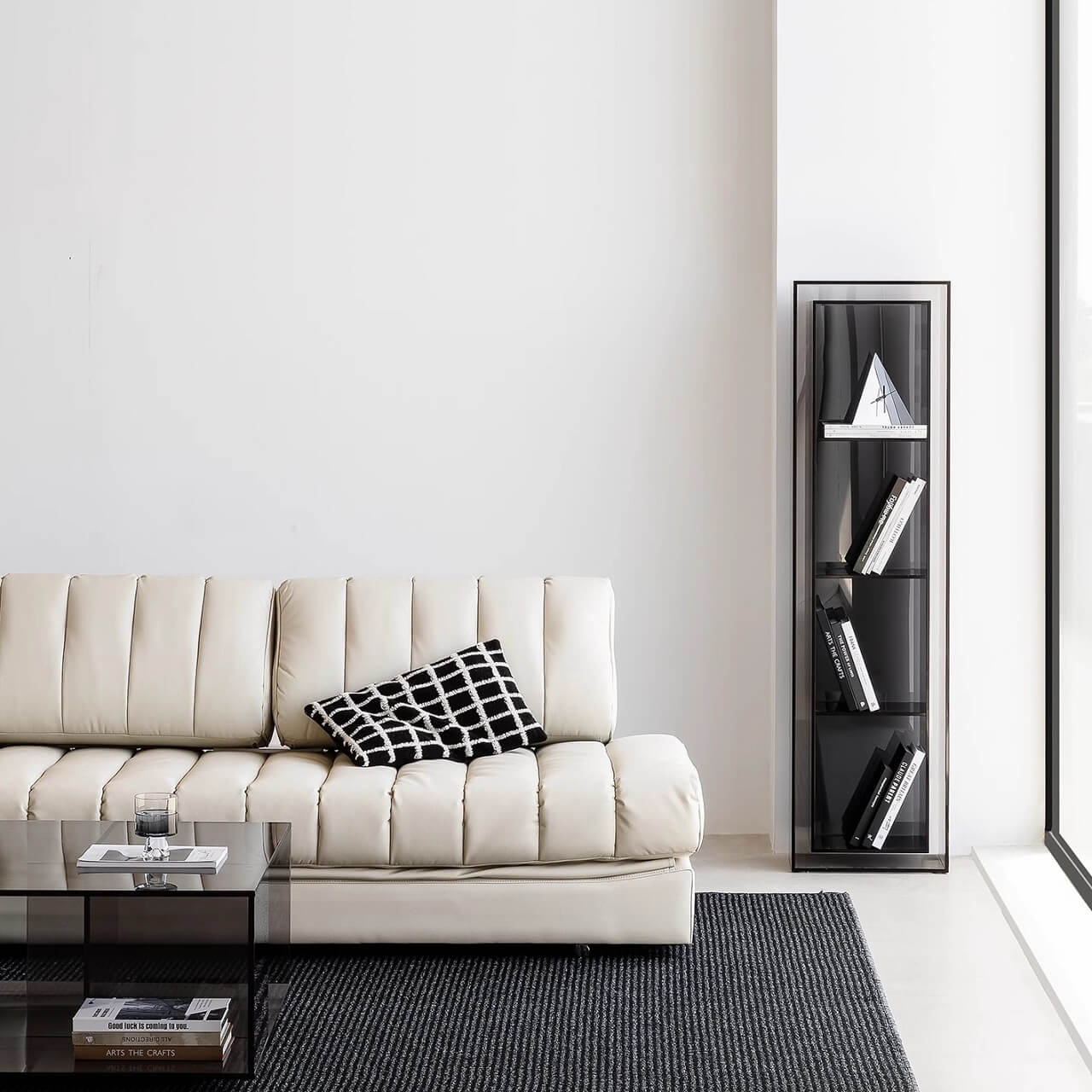 Black faux leather sofa bed with stainless steel frame and pillow arms for modern living rooms