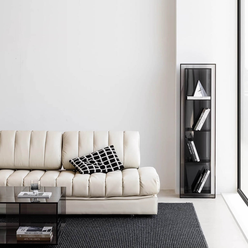 Black faux leather sofa bed with stainless steel frame and pillow arms for modern living rooms