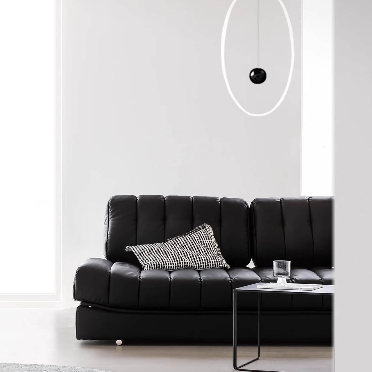 Black faux leather sofa bed with stainless steel frame and pillow arms for modern living rooms