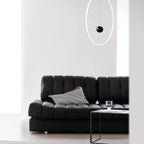 Black faux leather sofa bed with stainless steel frame and pillow arms for modern living rooms