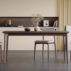 Elegant modern gray dining table with rock slab surface and solid wood support