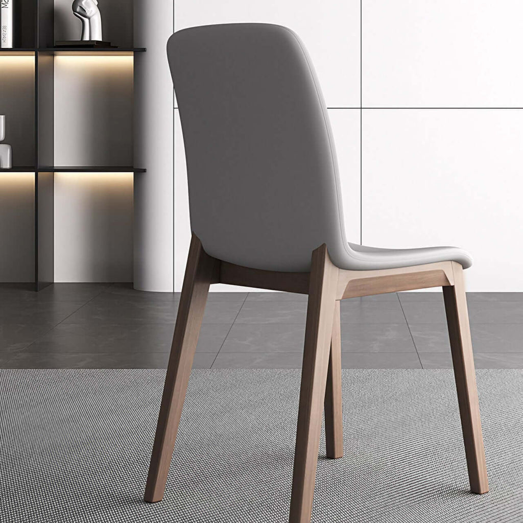Single modern grey leather dining chair with durable fan-back design and minimalist style