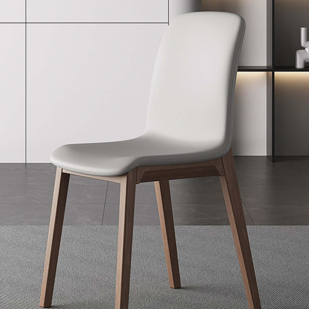 Single modern grey leather dining chair with durable fan-back design and minimalist style