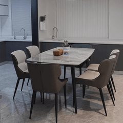 Modern grey dining table with bright rock surface and carbon steel legs in minimalist design