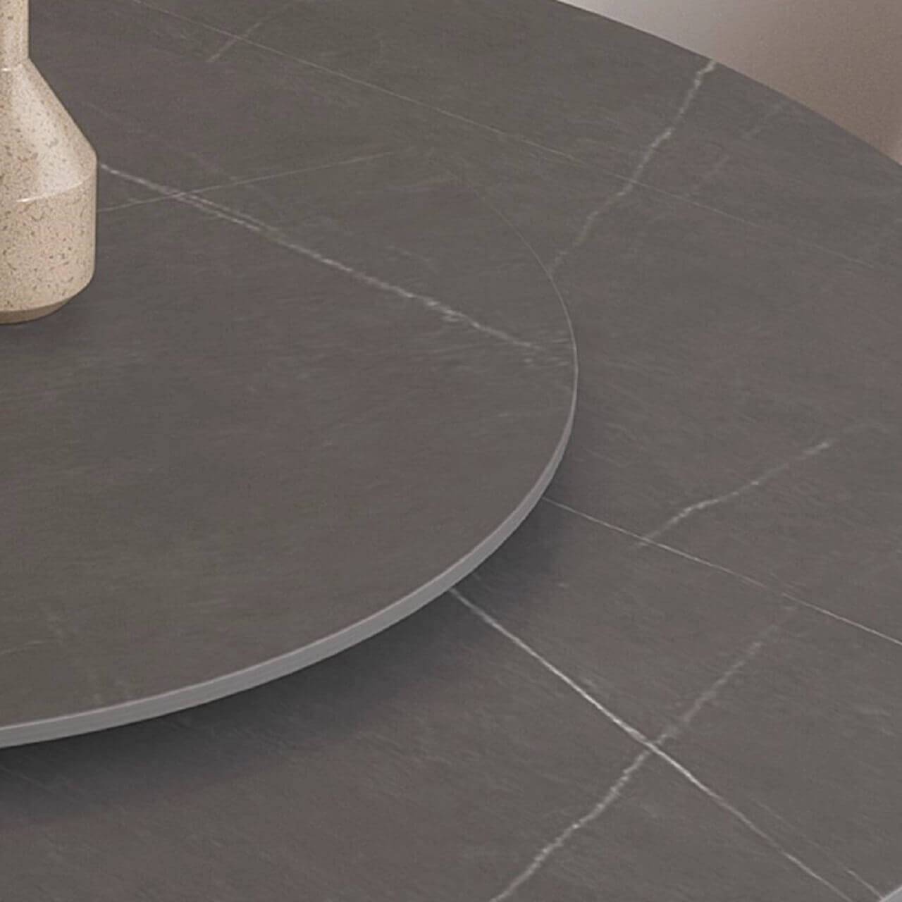 Grey round sintered stone dining table with rotating lazy Susan and simplistic design