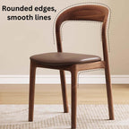 Brown leather dining chair with a modern curved back and simplistic design, single piece