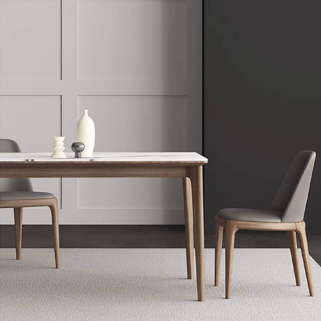 White rectangular sintered stone tabletop dining table with solid wood base in minimalist design