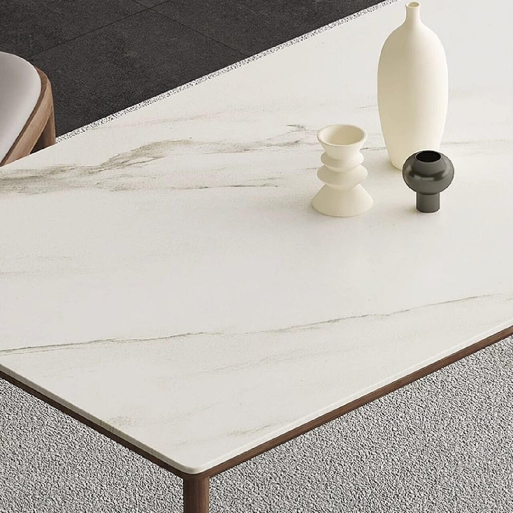 White rectangular sintered stone tabletop dining table with solid wood base in minimalist design