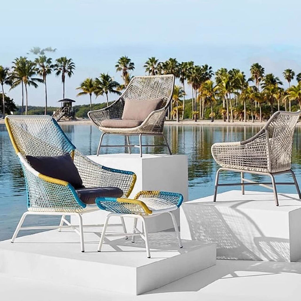 Outdoor PE rattan loveseat with metal legs and cushion pillows for patio seating