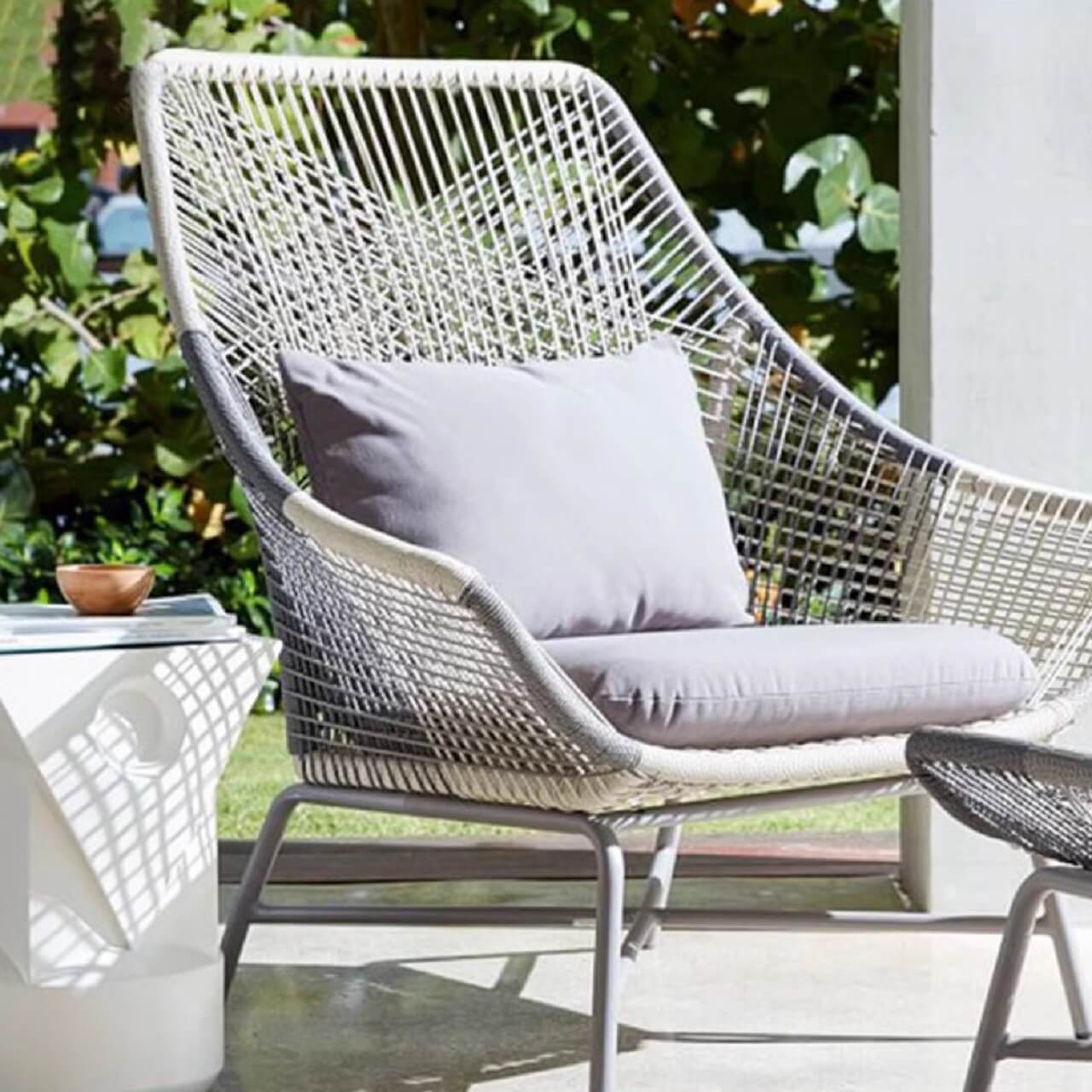 Outdoor PE rattan loveseat with metal legs and cushion pillows for patio seating