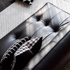 Black retro microfiber leather sofa bed with reclining and armless design for versatile comfort