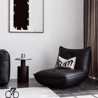 Black retro microfiber leather sofa bed with reclining and armless design for versatile comfort