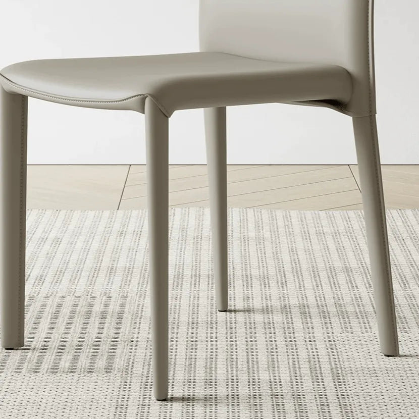 Saddle Leather Dining Chair Series with Sculpted Curves and Stackable Form