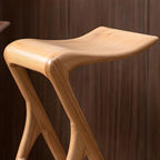 Sculpted Solid Wood Bar Stool with X Base and Ergonomic Saddle Seat