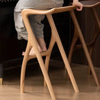 Sculpted Solid Wood Bar Stool with X Base and Ergonomic Saddle Seat