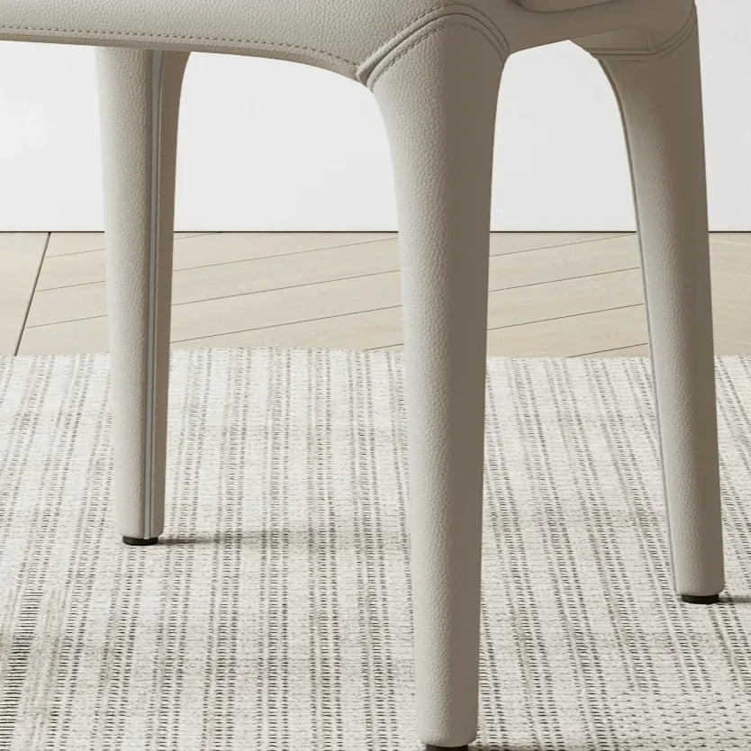 Sculptural Upholstered Dining Chair Series with Curved Arms and Slender Legs