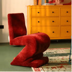 Sculptural Zigzag Chair Series With Zebra Print Textures and Soft Curved Upholstery