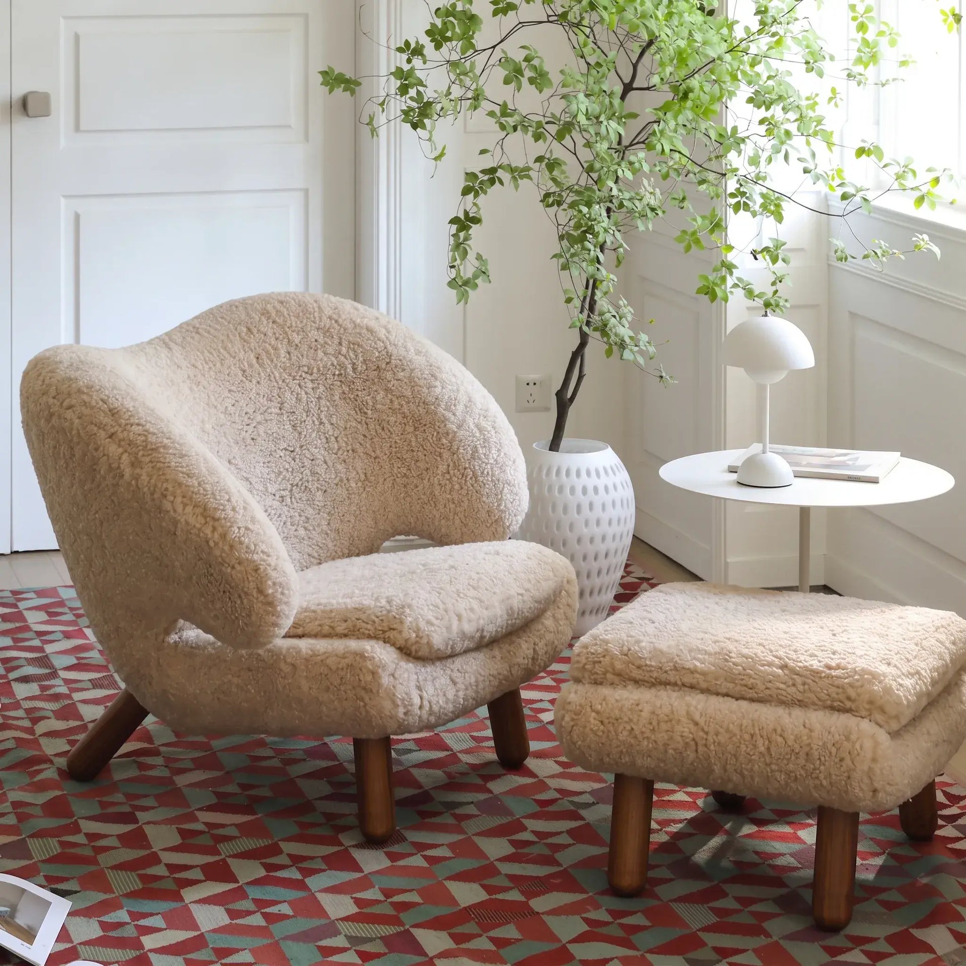 Shearling pelican chair series with walnut legs and an embrace lounge silhouette, available in multiple colors