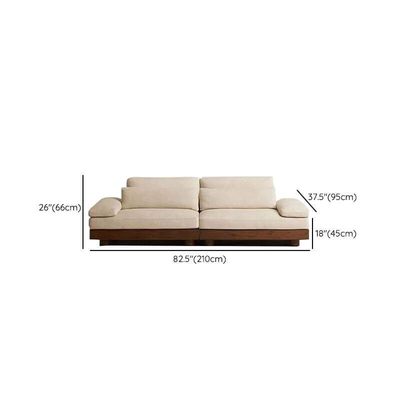 Cream Art Deco floor sofa with pillow back, pillow top arms, slipcover, and multiple pillows for seating 2 to 4 people dimensions
