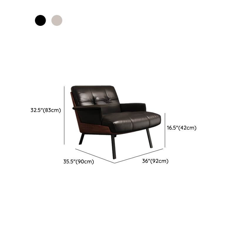 Living room featuring the button-tufted arm chair