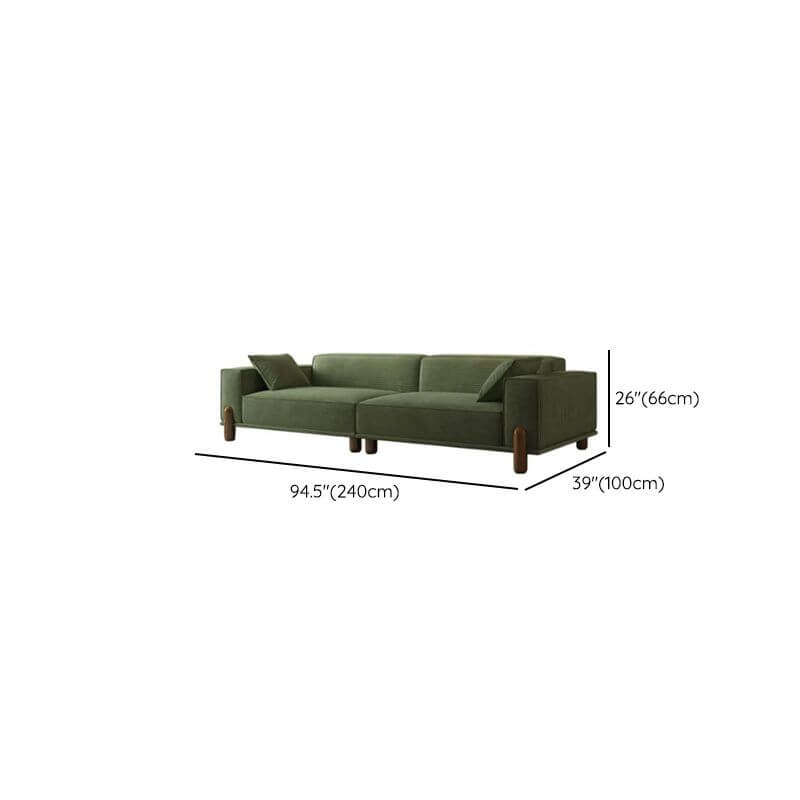 comfortable olive green sofa with blue accent pillows