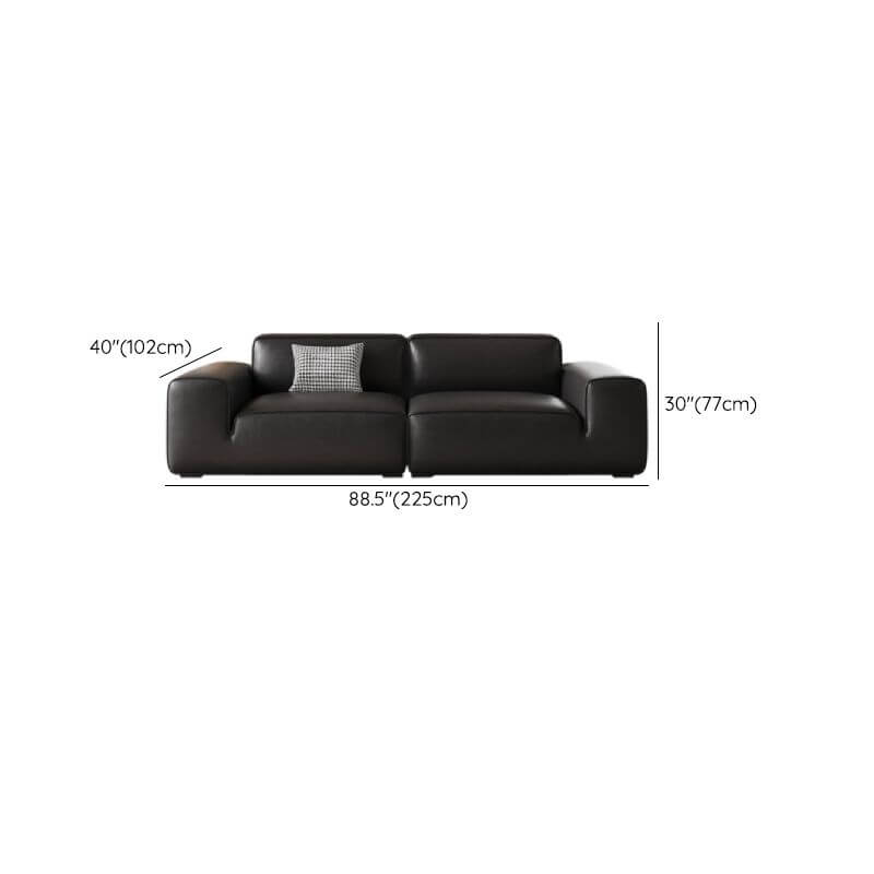 Comfortable black sofa with three pillows