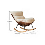 Rattan indoor rocking chair against a window