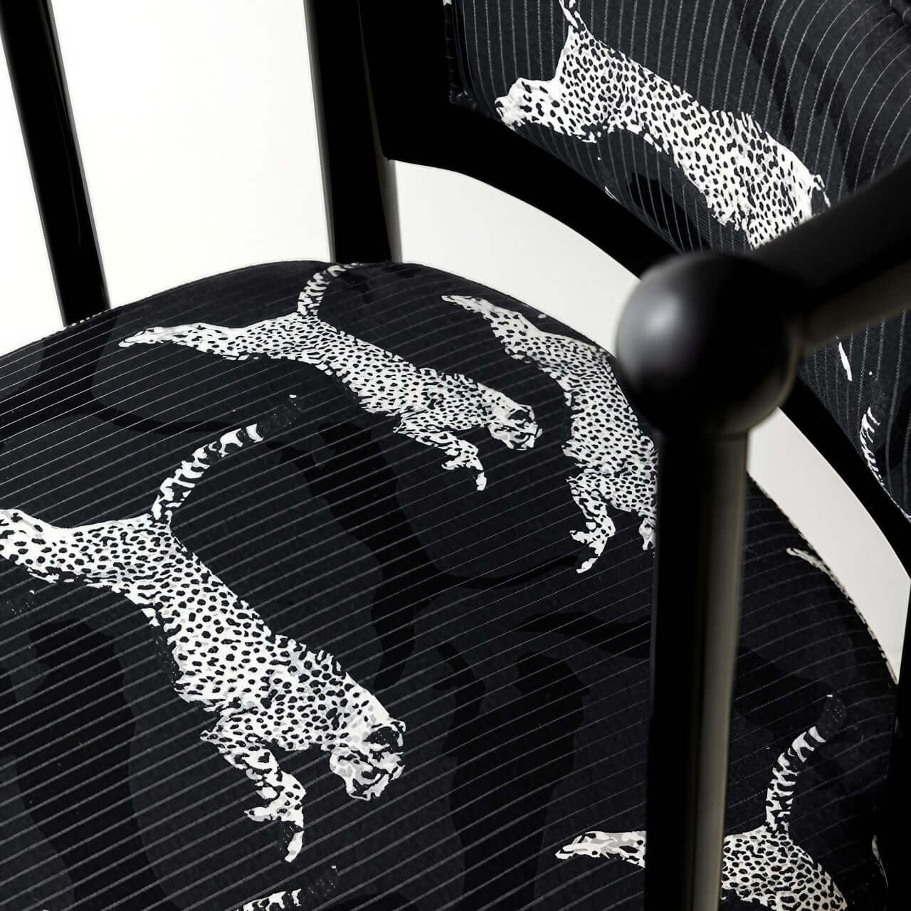 Single vintage dining chair with black fabric and leopard print upholstery